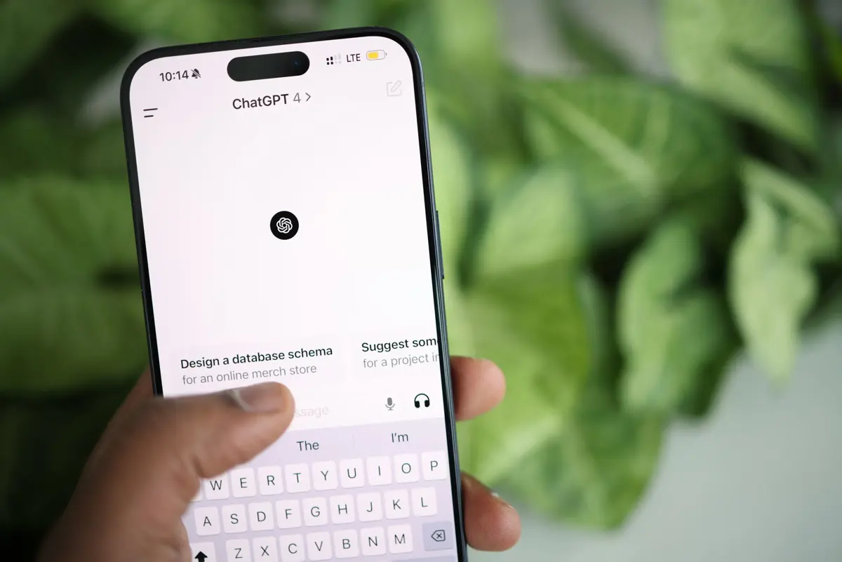 A person holding an iPhone with the ChatGPT 4 app open on screen