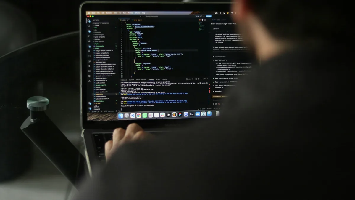 Developer working in a dark-themed code editor on a laptop screen