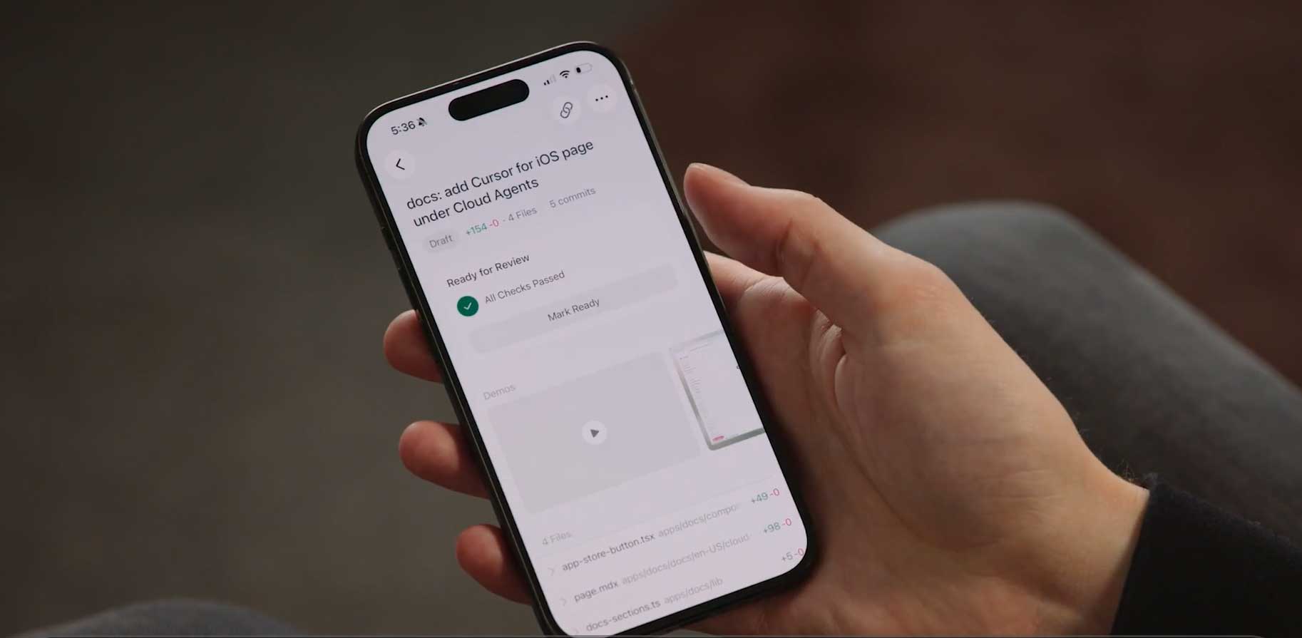 Cursor iOS app interface showing an AI agent running on a mobile phone