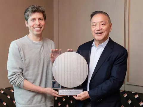 OpenAI President Greg Brockman and Broadcom CEO Hock Tan holding the Jalapeño custom AI inference chip at its official unveiling in June 2026