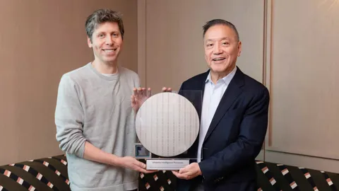 OpenAI President Greg Brockman and Broadcom CEO Hock Tan holding the Jalapeño custom AI inference chip at its official unveiling in June 2026