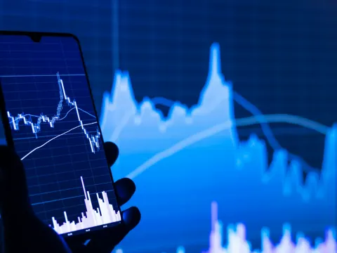 Financial trading screen displaying red declining stock market numbers and index data