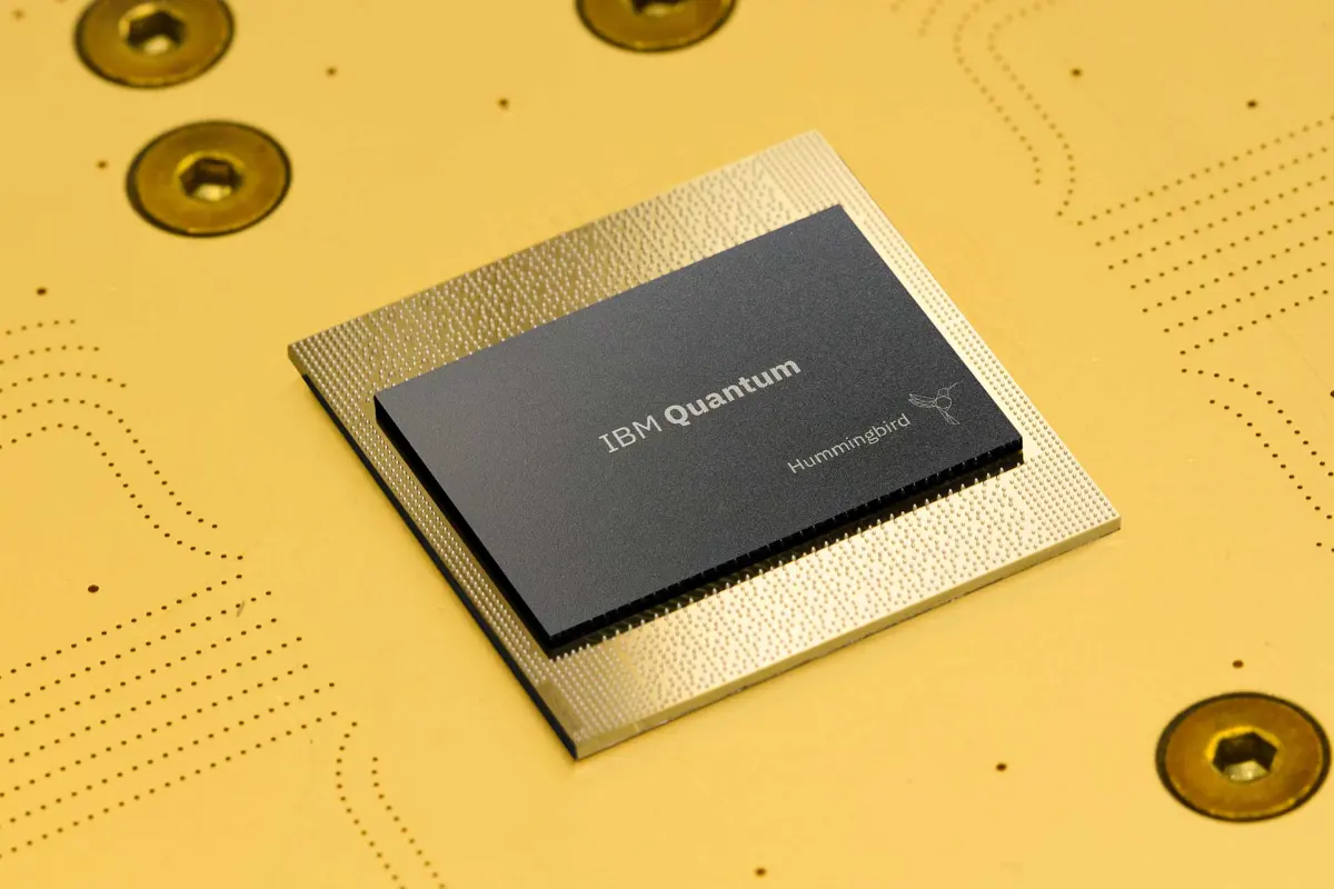 Close-up of a quantum computing processor with gold wiring and cryogenic hardware components in a research lab