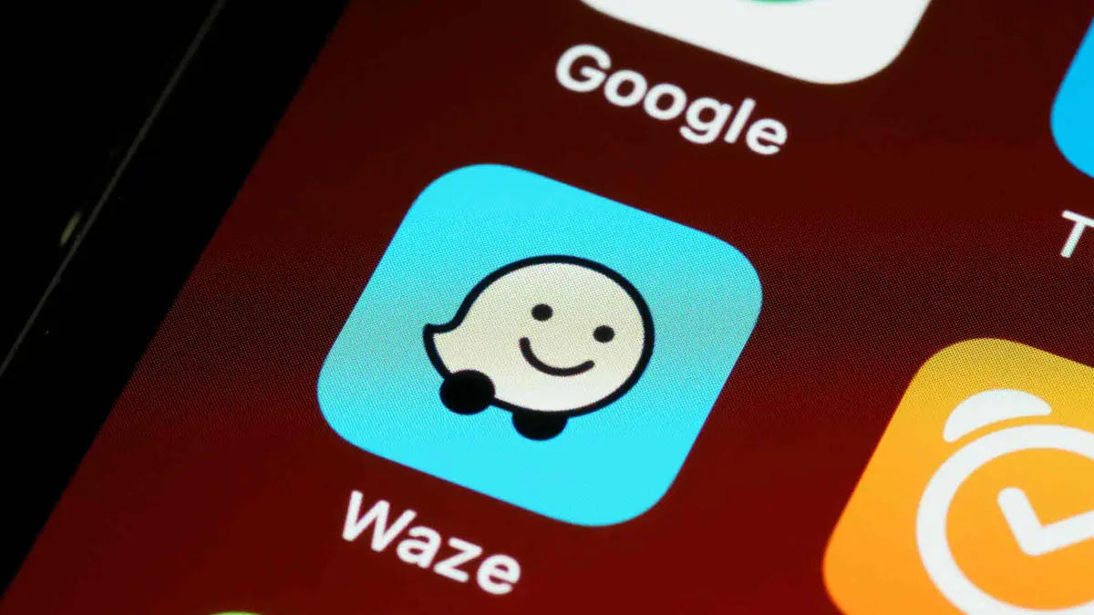 Waze app showing motorcycle mode routing with hazard indicators on a city map