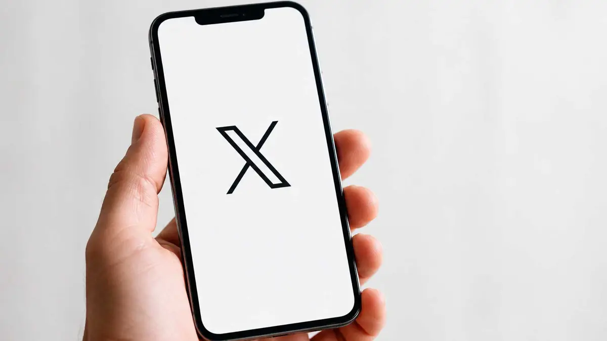 X app on an iPhone screen with video editor interface visible