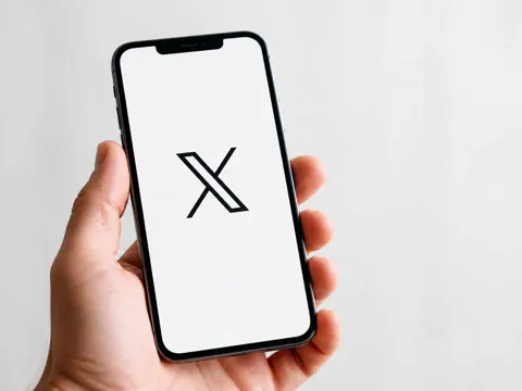 X app on an iPhone screen with video editor interface visible