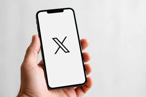 X app on an iPhone screen with video editor interface visible
